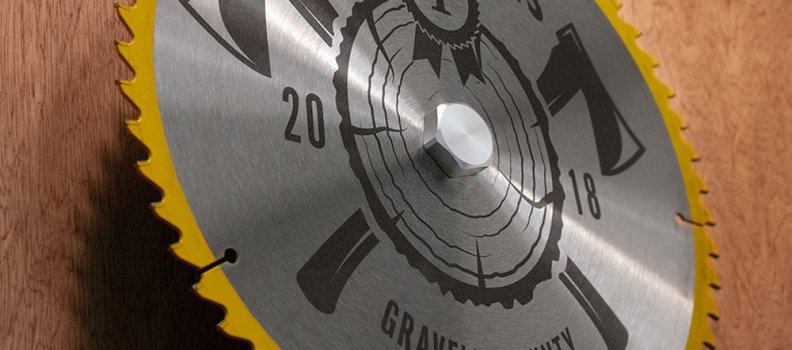 Laser engraved saw blade held with standard barrel and hex cap